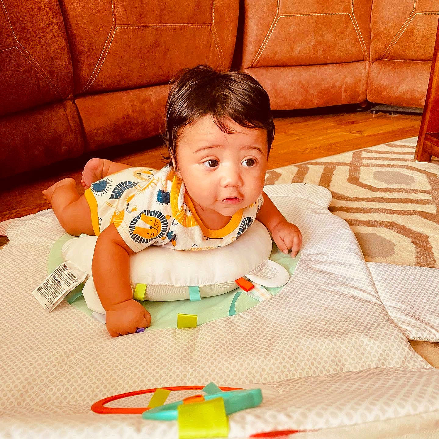 Aziel joined the competition — help win amazing prizes! baby, baby_toddler_clothing, bib, child, comfort, couch, finger, flooring, happy, hardwood, linens, pattern, person, room, sitting, sleeve, t_shirt, textile, toddler, tummy_time