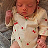 baby, sleeping, onesie, headband, bow, cherry_pattern, blanket, infant, cute, cozy, peaceful, newborn, soft, toddler, clothing, skin, hand, foot, portrait, indoor