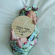 Octavia joined the competition — help win amazing prizes! newborn, baby, infant, sleeping, blanket, headband, floral_pattern, sign, announcement, cute, wrapped, feet, hand, white_bedding, portrait, peaceful, soft_light, indoors, child, person