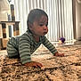 Bryson is registered to the contest to win money with this photo: baby, child, crawling, carpet, striped_pajamas, indoor, natural_light, vertical_blinds, cat_tree, purple_ball, floor, person, home, soft_light, curious, young_child, furniture, plush, patterned_rug, cozy