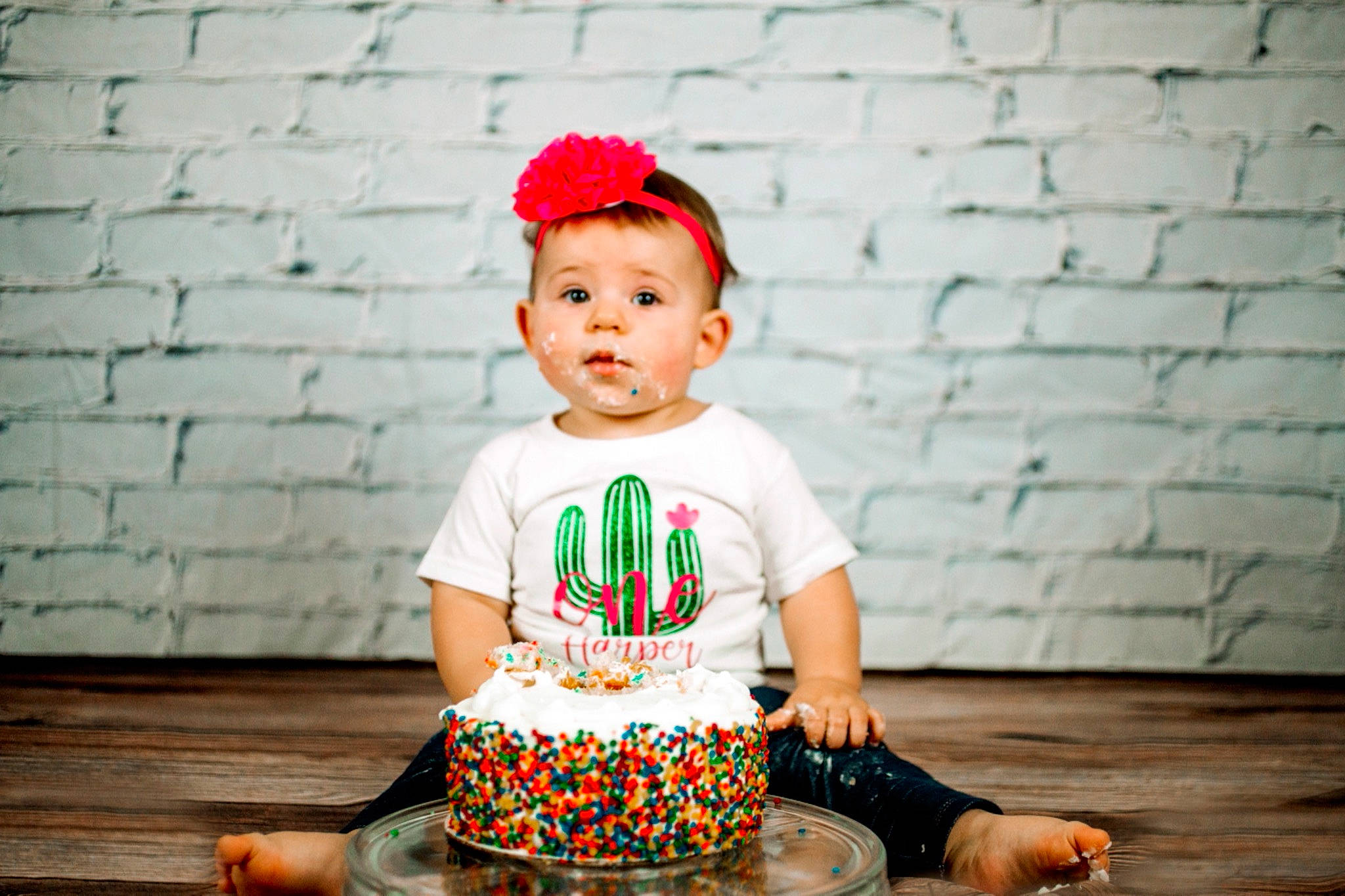 Harper joined the competition — help win amazing prizes! baby_toddler_clothing, cap, child, flash_photography, grass, green, happy, light, magenta, orange, pattern, person, photograph, portrait_photography, sitting, skin, sleeve, t_shirt, toddler, wood