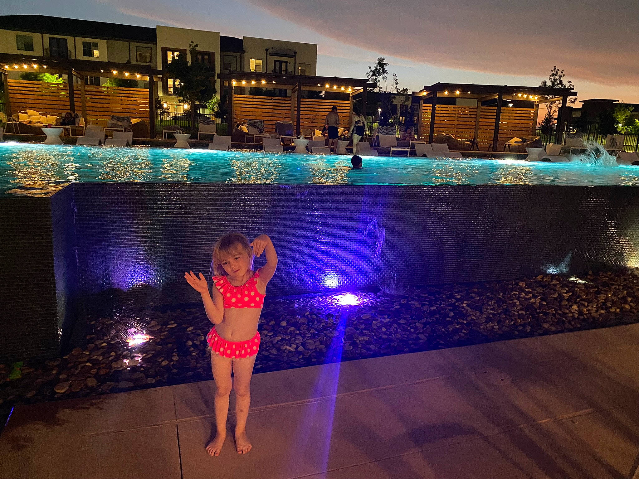 Angelina joined the competition — help win amazing prizes! body_of_water, building, city, cloud, condominium, fun, happy, human_settlement, leisure, light, person, plant, rectangle, resort_town, sky, sunset, swimming_pool, tree, water, water_feature