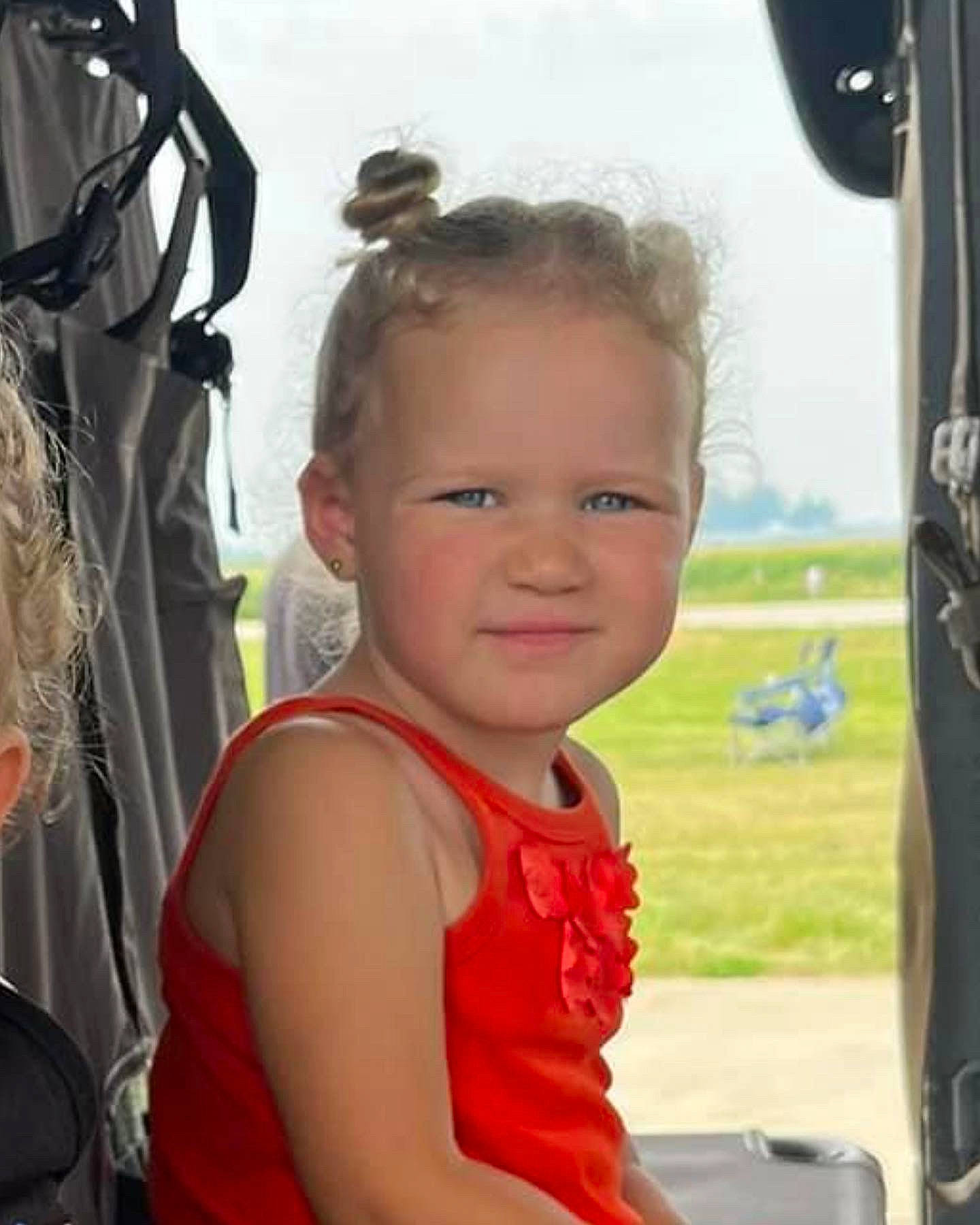 Catie is registered to the contest to win money with this photo: aerospace_engineering, air_travel, aircraft, aviation, child, eyewear, flight, fun, hairstyle, happy, leisure, light_aircraft, person, personal_protective_equipment, recreation, sky, smile, t_shirt, toddler, travel