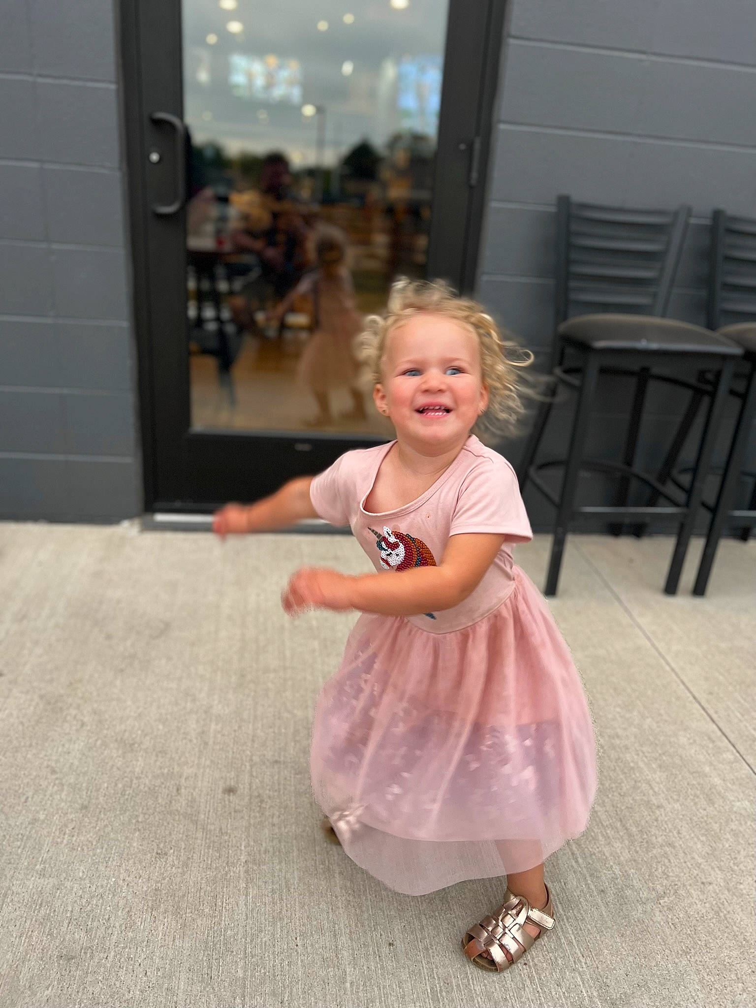 Catie joined the competition — help win amazing prizes! baby_toddler_clothing, blond, chair, child, door, dress, event, floor, flooring, fun, hair, happy, human_leg, joint, joy, magenta, person, pink, sandal, shoulder