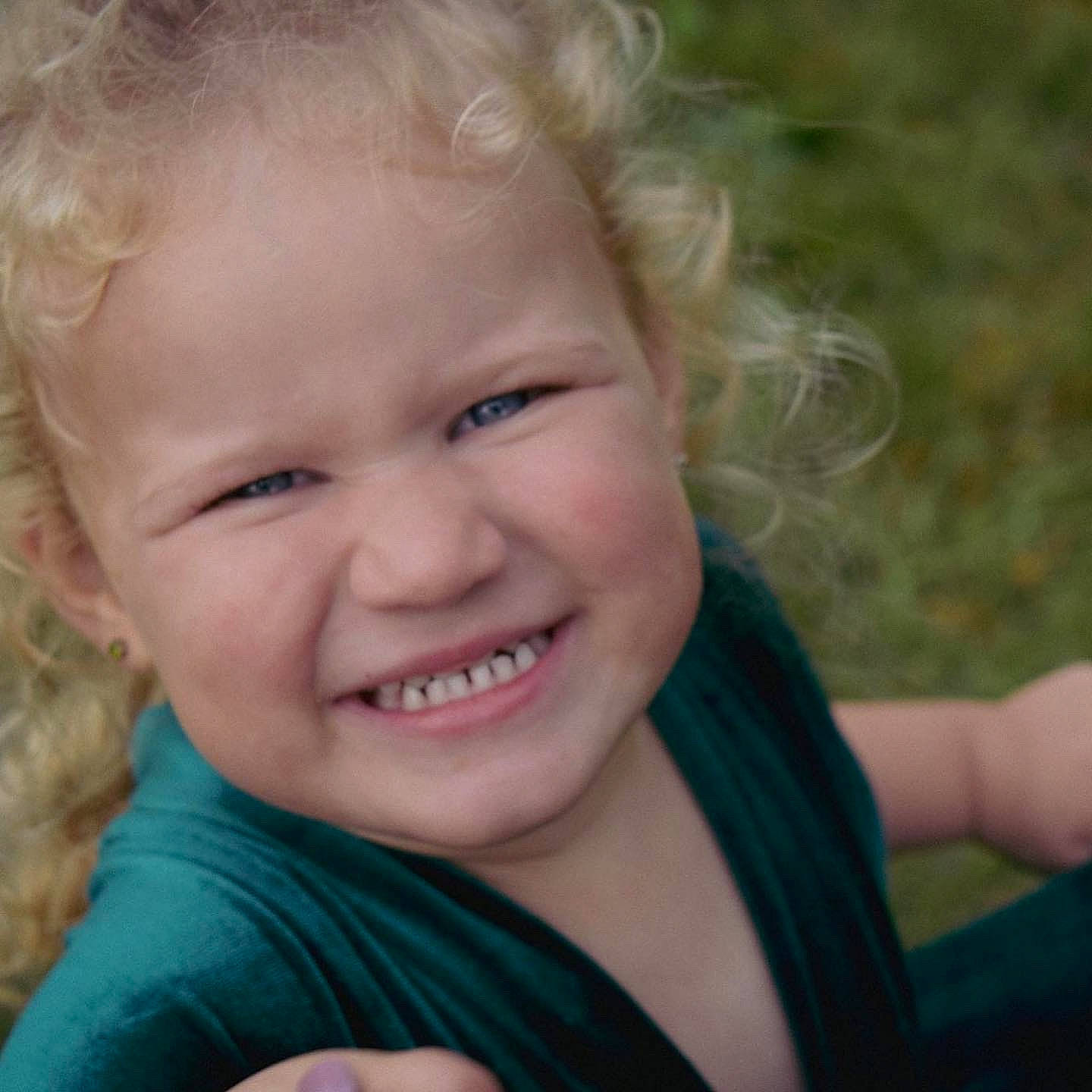 Catie is registered to the contest to win money with this photo: arm, cheek, chin, ear, eyebrow, face, facial_expression, flash_photography, grass, happy, human_body, iris, joy, lip, nose, people_in_nature, person, plant, skin, smile