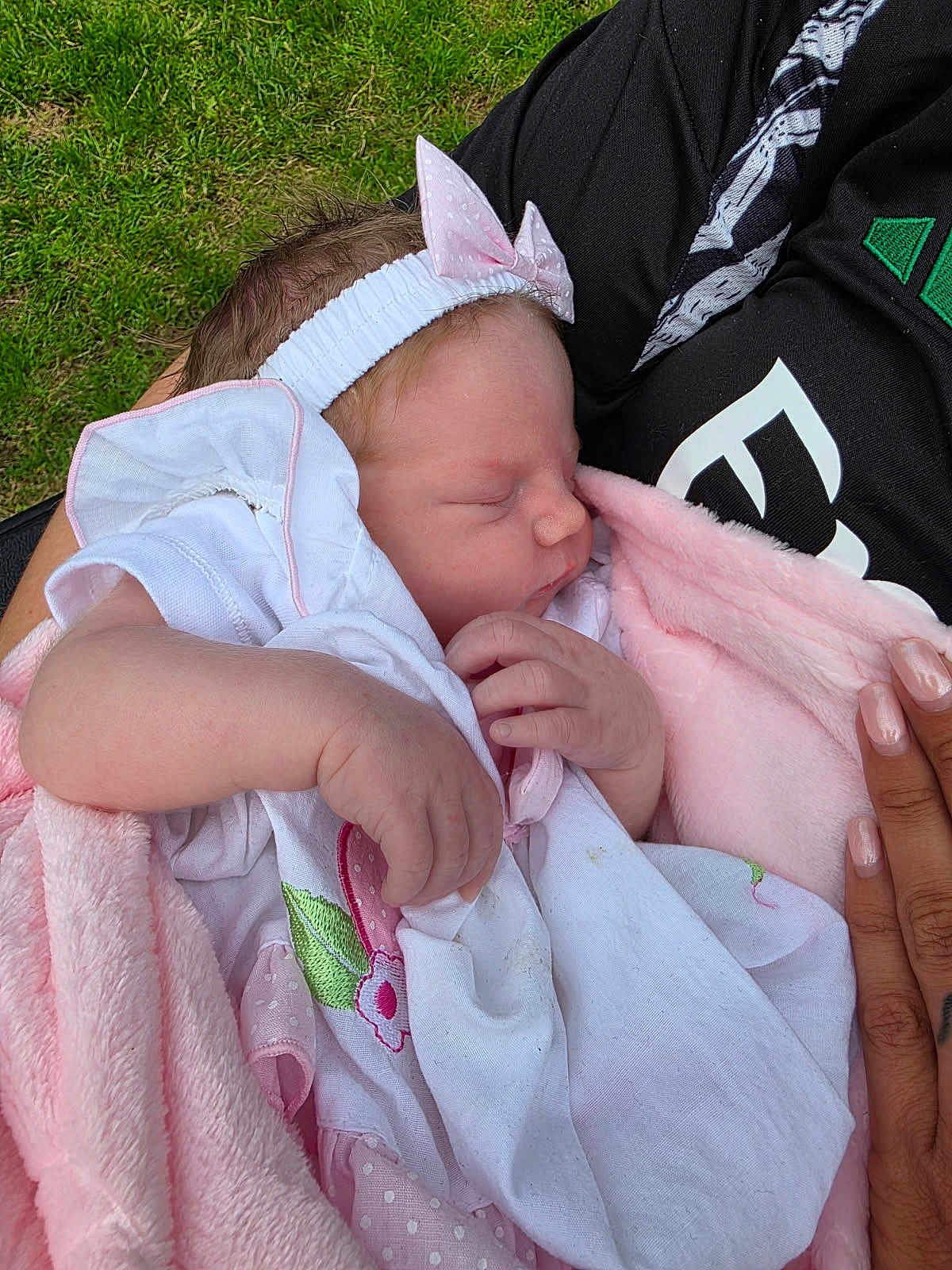 Patciè-Eileen is registered to the contest to win money with this photo: baby, blanket, bow, child, closeup, gentle, grass, hands, headband, holding, infant, manicured_nails, newborn, outdoor, peaceful, person, pink, sleeping, soft_texture, white_clothing