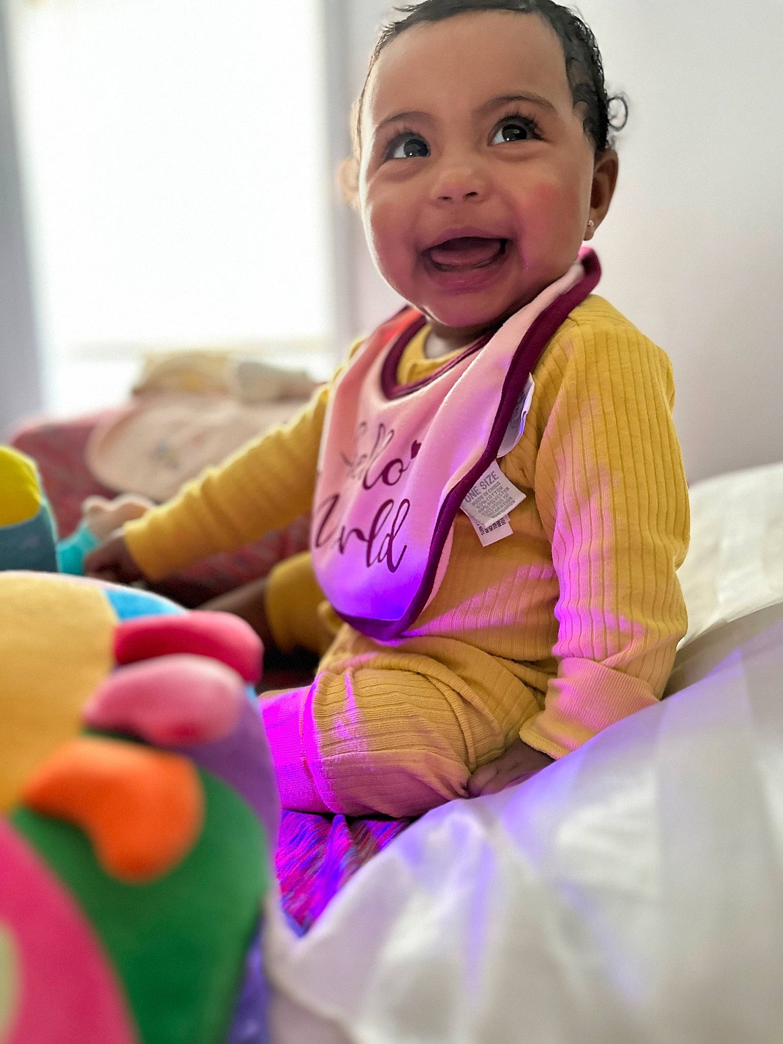 Jaylani joined the competition — help win amazing prizes! baby_toddler_clothing, cheek, child, event, facial_expression, finger, fun, gesture, happy, human_body, leisure, magenta, person, pink, purple, sitting, skin, sleeve, smile, snapshot