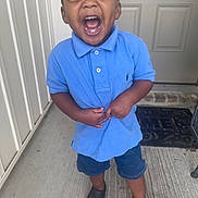 Jayjay joined the competition — help win amazing prizes! toddler, child, boy, smiling, laughing, blue_shirt, denim_shorts, porch, door, welcome_mat, concrete_floor, casual_clothing, shorts, footwear, black_shoes, happy, joyful, outdoor, person, young_child