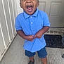 toddler, child, boy, smiling, laughing, blue_shirt, denim_shorts, porch, door, welcome_mat, concrete_floor, casual_clothing, shorts, footwear, black_shoes, happy, joyful, outdoor, person, young_child