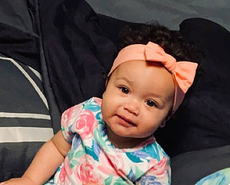 Kira joined the competition — help win amazing prizes! baby, baby_toddler_clothing, cheek, child, chin, comfort, eyebrow, eyelash, fun, happy, headwear, linens, nose, person, room, sitting, skin, sleeve, smile, t_shirt