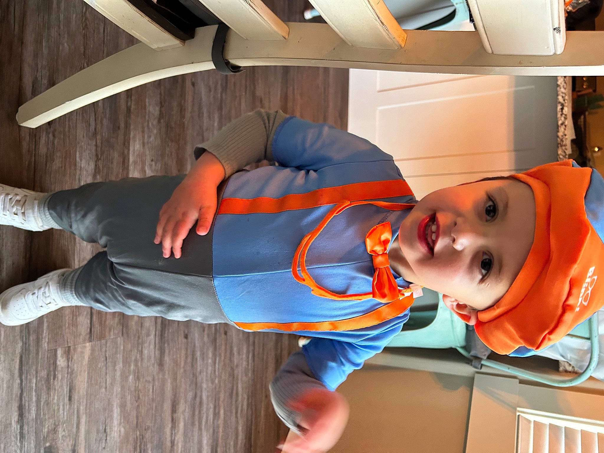 Kayson joined the competition — help win amazing prizes! child, clothing, comfort, costume, electric_blue, flooring, fun, hardwood, hat, headgear, headwear, knee, orange, person, personal_protective_equipment, room, sleeve, toddler, vacation, white