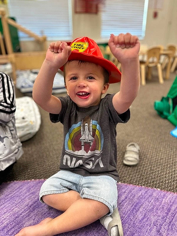 Kayson is registered to the contest to win money with this photo: baby, baby_toddler_clothing, baseball_cap, cap, child, event, fun, happy, headwear, holiday, joy, leisure, person, play, room, shorts, sitting, skin, sleeve, smile