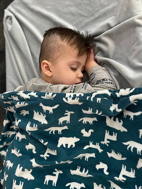 Kayson is registered to the contest to win money with this photo: baby, baby_toddler_clothing, cheek, child, comfort, flash_photography, grass, happy, human, linens, mammal, military_camouflage, pattern, people, person, sitting, sleeve, t_shirt, textile, toddler