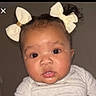 Mia is registered to the contest to win money with this photo: baby, child, face, hair_bow, cute, portrait, infant, young_child, expression, curious, indoors, clothing, closeup, head, person, skin, eyes, mouth, cheeks, adorable