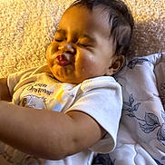 Starr joined the competition — help win amazing prizes! baby, child, face, expression, puckered_lips, shirt, blanket, quilt, bed, indoor, person, cute, skin, hair, sleepwear, comfort, resting, happy, young, infant