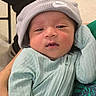Jiron Caelix is registered to the contest to win money with this photo: newborn, baby, infant, child, portrait, close_up, face, eyes, sleepy, hat, beanie, nike, clothing, mint_green, onesie, held, indoor, photography, baby_fashion, adorable