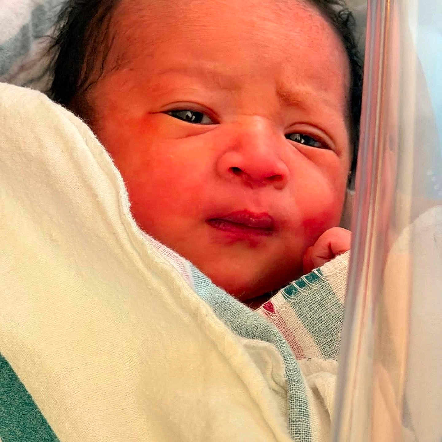 Jiron Caelix joined the competition — help win amazing prizes! newborn, baby, infant, portrait, face, eyes, hair, hospital, crib, blanket, swaddle, bedding, textile, close_up, lying_down, serious_expression, indoor, photography, head, child