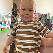 Phärel a rejoint le concours — aidez-le/la à gagner de superbes lots ! toddler, child, indoor, portrait, smiling, striped_shirt, jeans, pony_tail, playful, toy, living_room, clock, wooden_floor, furniture, person, casual_clothing, happy, young_child, cute, home