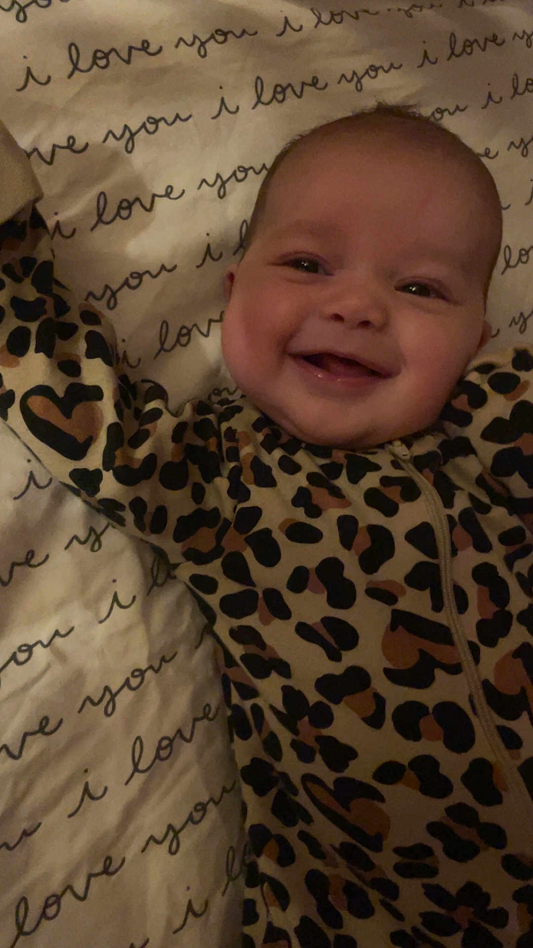 Adalynn joined the competition — help win amazing prizes! baby, smiling, leopard_print, onesie, blanket, text_pattern, happy, infant, face, cute, child, lying_down, sleepwear, joy, person, closeup, indoor, cheerful, infancy, patterned_clothing