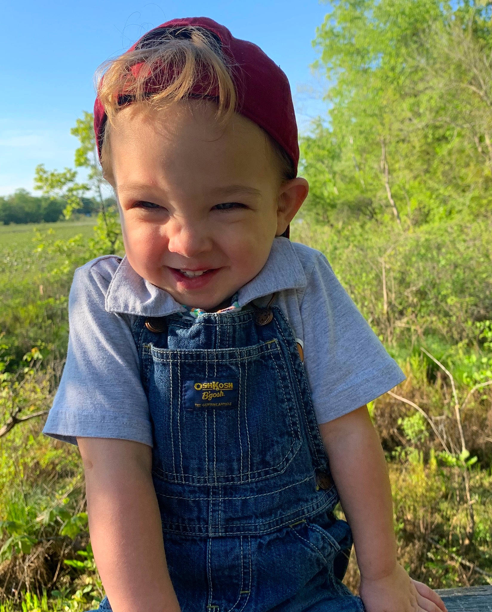 Tristan is registered to the contest to win money with this photo: child, child_model, denim, grass, jeans, joy, neck, person, photography, sitting, smile, textile, toddler