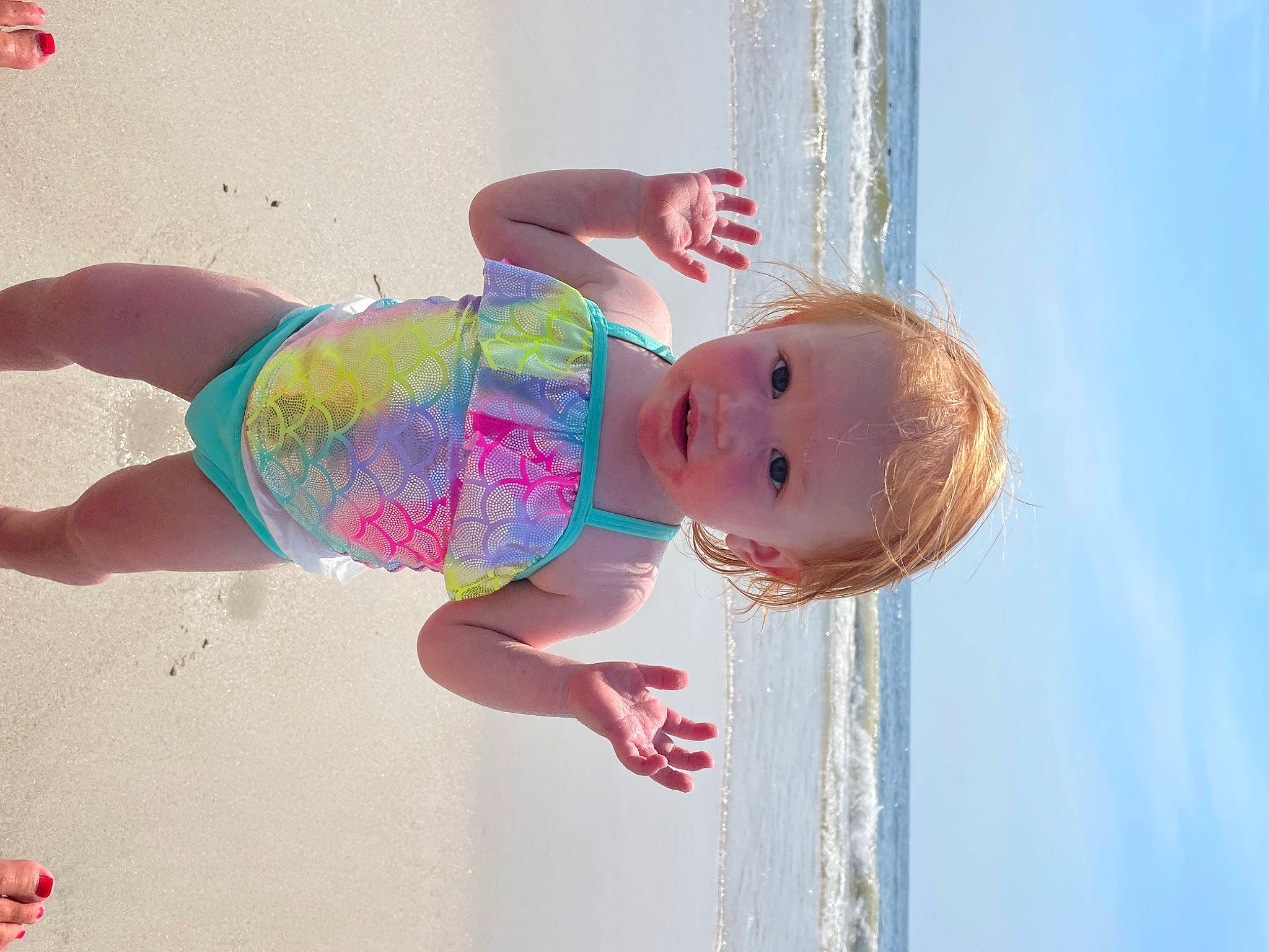 Peytan joined the competition — help win amazing prizes! azure, baby, baby_toddler_clothing, beach, body_of_water, child, cloud, fun, happy, leisure, pattern, people_in_nature, people_on_beach, person, pink, skin, sky, standing, thigh, toddler