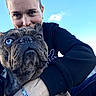 Simba participe au concours pour gagner de l'argent avec cette photo : animal, blue_sky, bracelet, casual_clothing, close_up, cute, dog, embrace, french_bulldog, friendship, happy, heterochromia, love, outdoor, person, pet, portrait, rock, selfie, sky