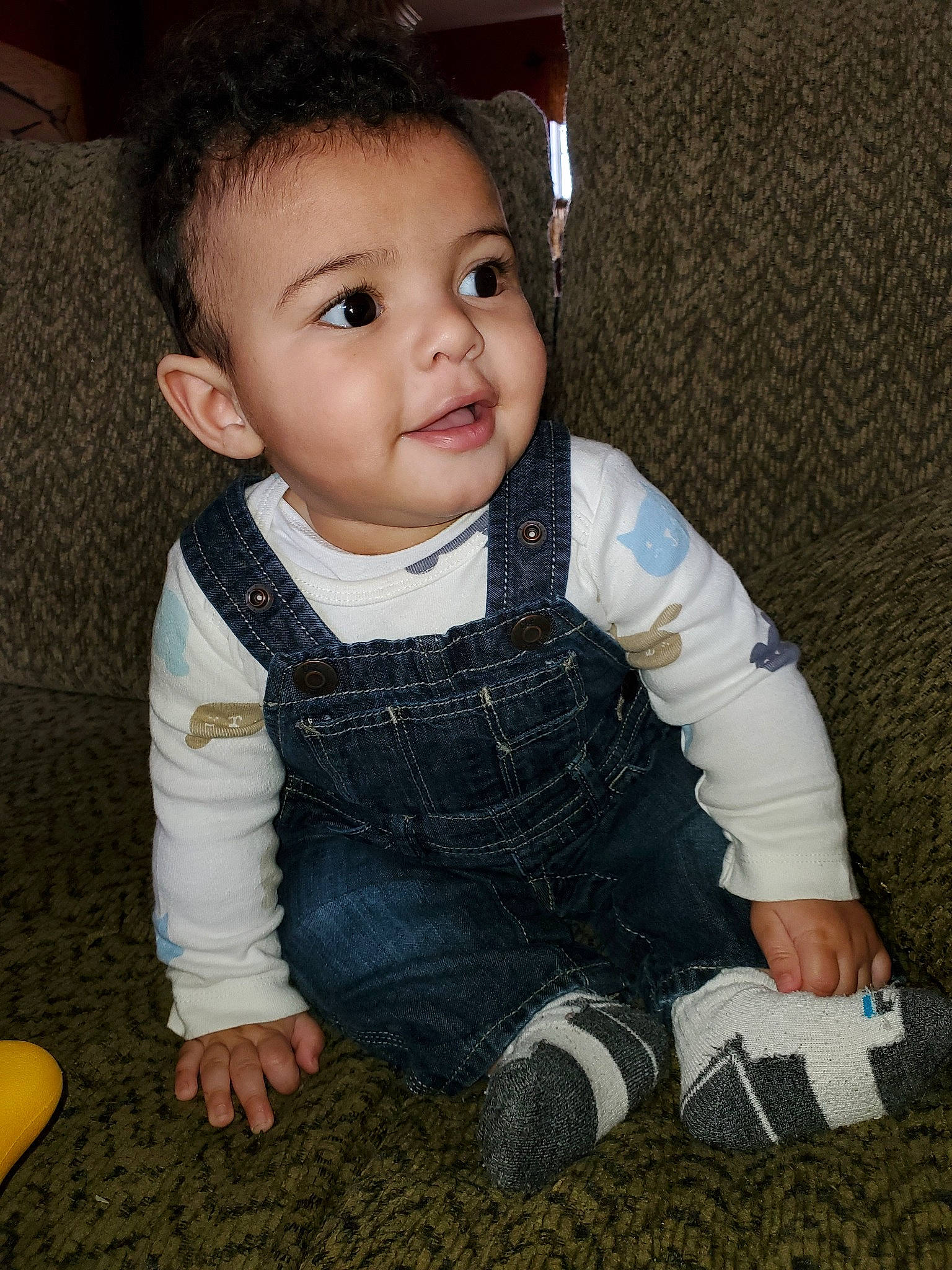 Mack is registered to the contest to win money with this photo: baby, baby_toddler_clothing, cheek, child, cool, eye, person, sitting, skin, smile, standing, toddler