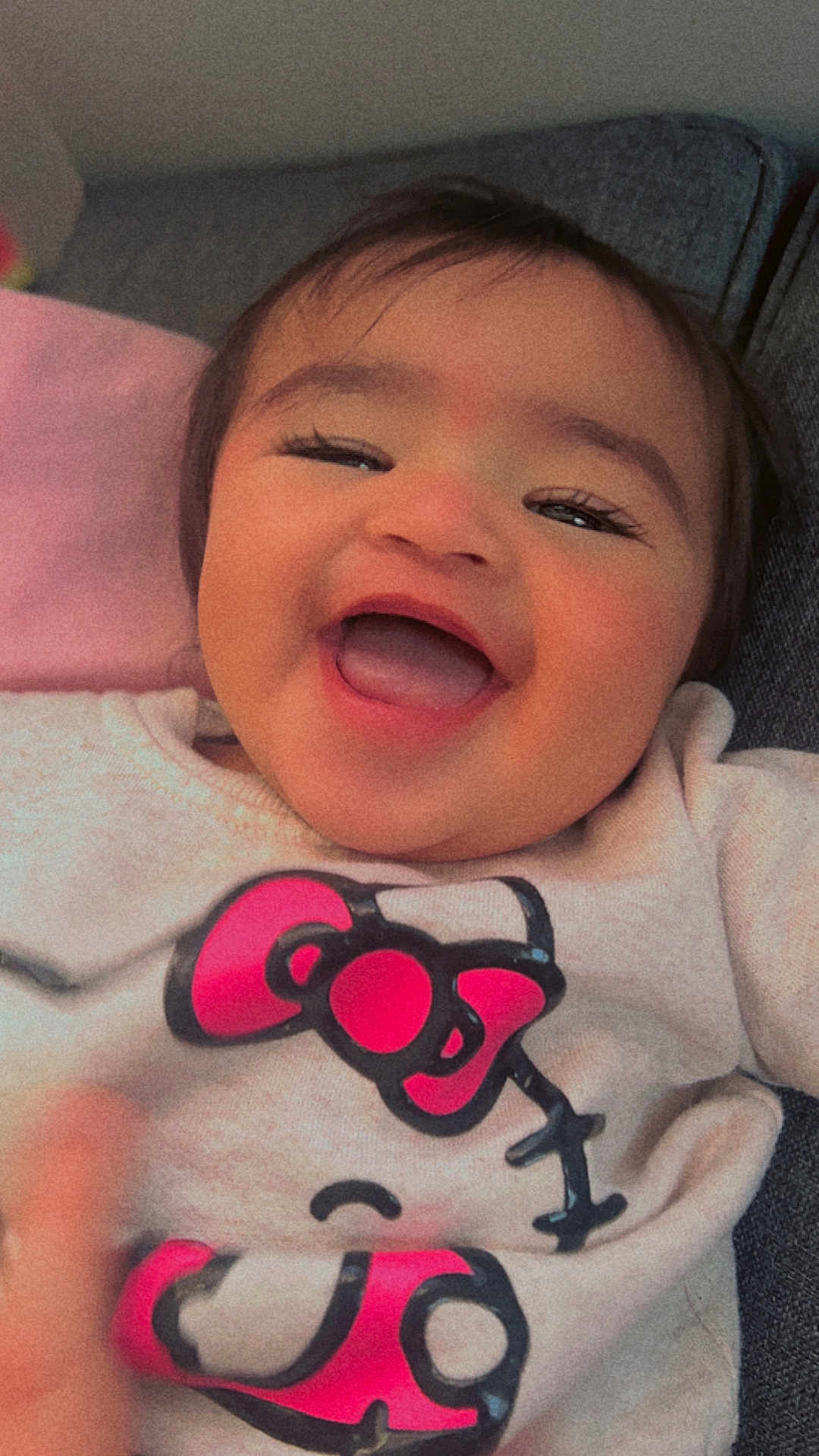 Janella is registered to the contest to win money with this photo: baby, smiling, happy, face, child, clothing, sweater, cartoon, pink, cute, portrait, closeup, infant, indoor, person, joyful, expression, young, toddler, apparel