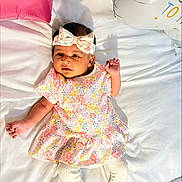 Dvija joined the competition — help win amazing prizes! baby, infant, bow, dress, floral_pattern, white_bed, balloon, pink_balloon, white_balloon, star_shaped, lying_down, cute, child, portrait, happy, indoors, fabric, clothing, person, smiling