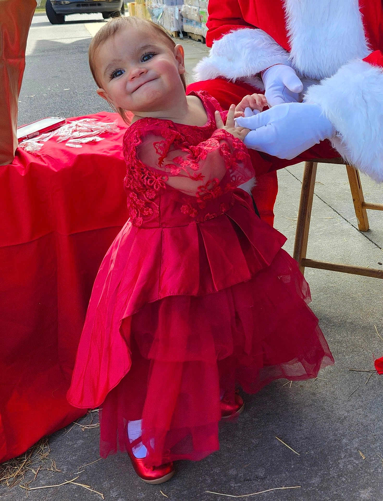 Ivory is registered to the contest to win money with this photo: toddler, child, red_dress, smiling, holiday, santa_claus, holding_hands, outdoor, sidewalk, festive, happy, person, costume, celebration, red_shoes, white_gloves, event, cute, portrait, dress