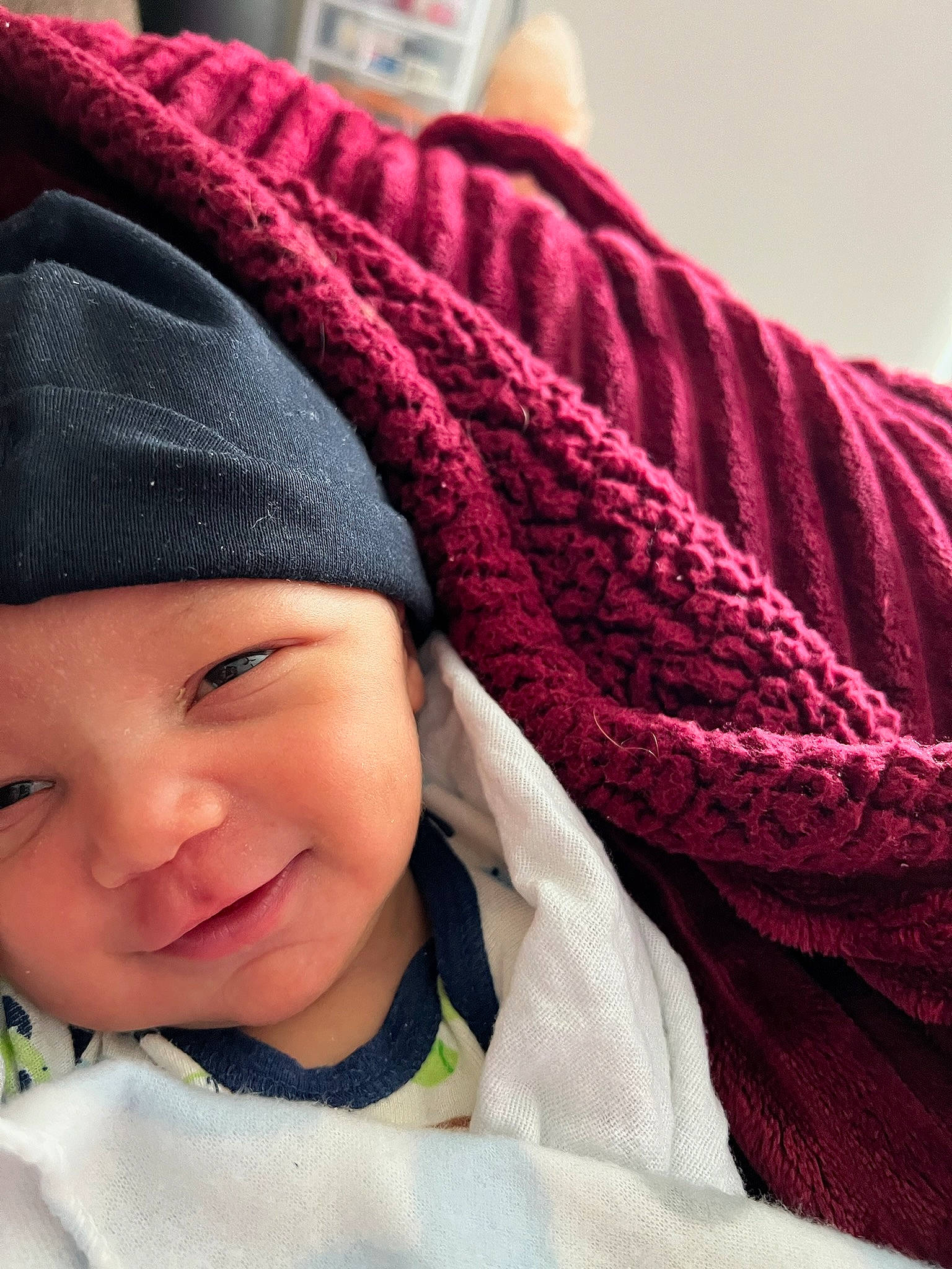 Zahkai is registered to the contest to win money with this photo: baby, baby_toddler_clothing, beanie, cap, carmine, cheek, child, comfort, face, fashion_accessory, happy, headwear, knit_cap, magenta, outerwear, pattern, person, smile, textile, toddler