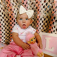 Lakelynn is registered to the contest to win money with this photo: baby, child, toy, pink, bow, crocheted_blanket, portrait, indoor, cute, playful, infant, clothing, doll, seated, expression, face, headband, person, smile, decor
