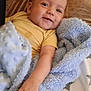 Mathéo participe au concours pour gagner de l'argent avec cette photo : baby, bedding, blanket, blue_blanket, brown_couch, child, couch, cozy, cute, face, hand, happy, indoors, infant, portrait, resting, smile, star_pattern, texture, yellow_shirt