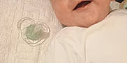 Mathéo participe au concours pour gagner de l'argent avec cette photo : baby, baby_boy, baby_girl, blanket, child, closeup, cute, face, happy, head, indoors, infant, lying_down, newborn, pacifier, person, portrait, skin, smiling, white_clothing