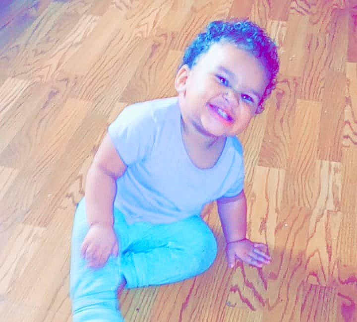Kamari is registered to the contest to win money with this photo: baby_toddler_clothing, blue, cheek, chin, eye, flash_photography, floor, flooring, happy, hardwood, head, iris, joy, nose, person, skin, smile, standing, toddler, varnish