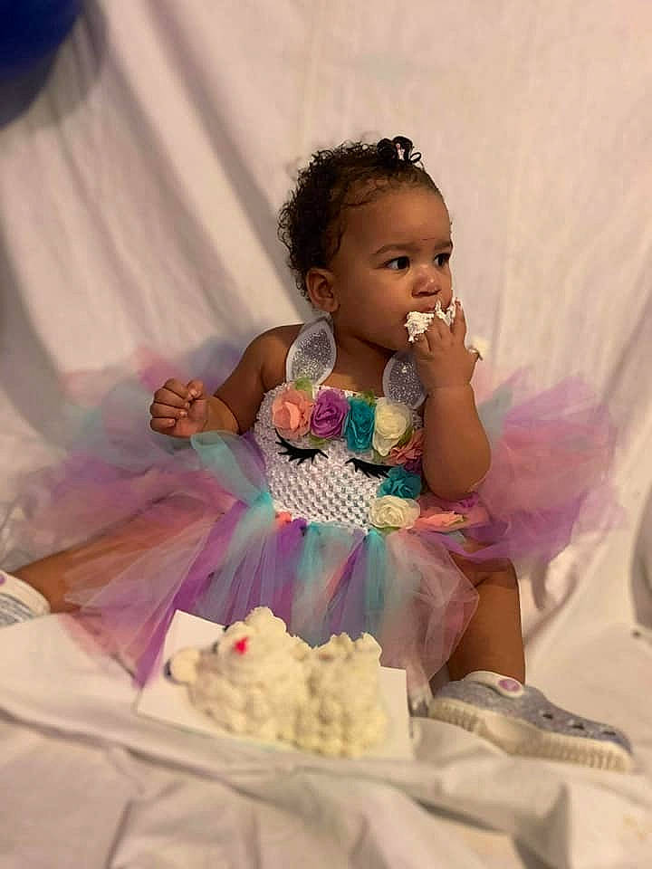 Kamari is registered to the contest to win money with this photo: baby_toddler_clothing, bridal_clothing, child, dress, event, fashion_design, flash_photography, formal_wear, fun, gown, happy, headpiece, icing, people, person, petal, pink, ruffle, sugar_cake, toddler