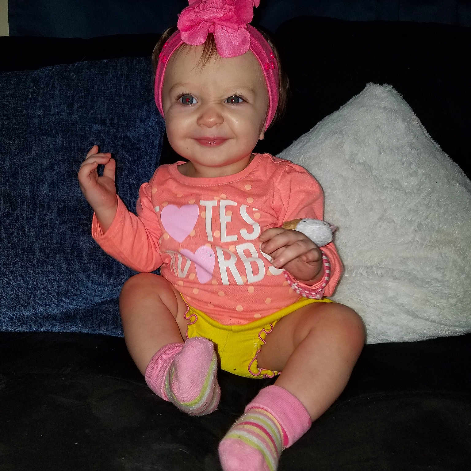 Nyla Rose is registered to the contest to win money with this photo: child, costume, fun, girl, hand, headgear, human_body, human_hair_color, infant, joy, leg, organ, person, pink, product, sitting, skin, smile, toddler