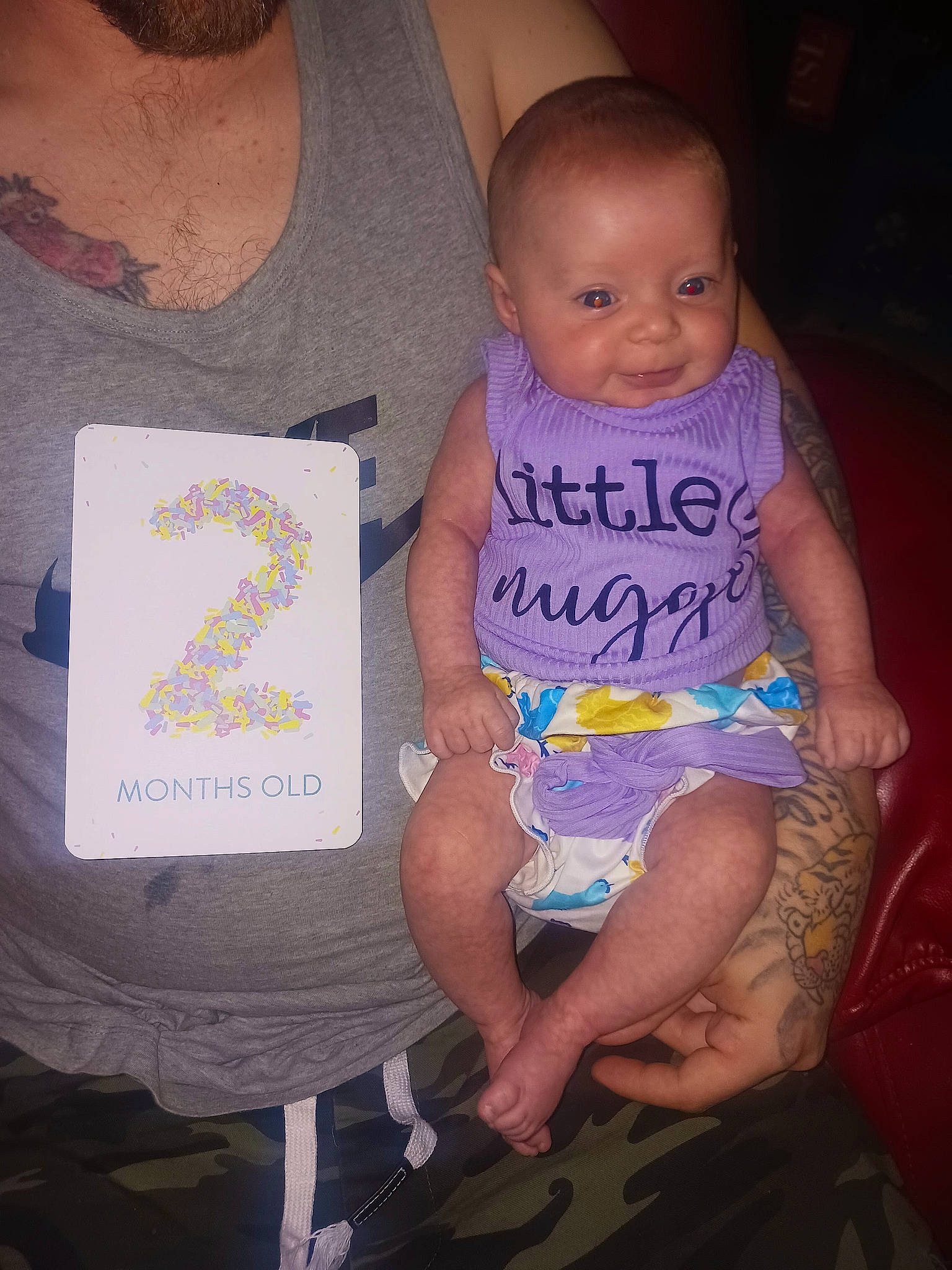 Harleigh is registered to the contest to win money with this photo: baby, baby_products, baby_toddler_clothing, chair, cheek, child, cool, finger, fun, happy, human, lap, organ, pattern, person, pink, sitting, sleeve, t_shirt, thigh