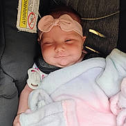 Jade Royal joined the competition — help win amazing prizes! baby, infant, child, blanket, car_seat, headband, pacifier, smile, winking, face, cute, indoors, soft_texture, clothing, comfort, wrapped, pink, white, gray, seat