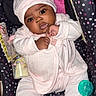 Jaylani is registered to the contest to win money with this photo: baby, infant, car_seat, pink_clothing, hat, pacifier, bottle, polka_dots, cute, child, indoors, seat, apparel, face, person, newborn, expression, resting, footwear, sleepsuit