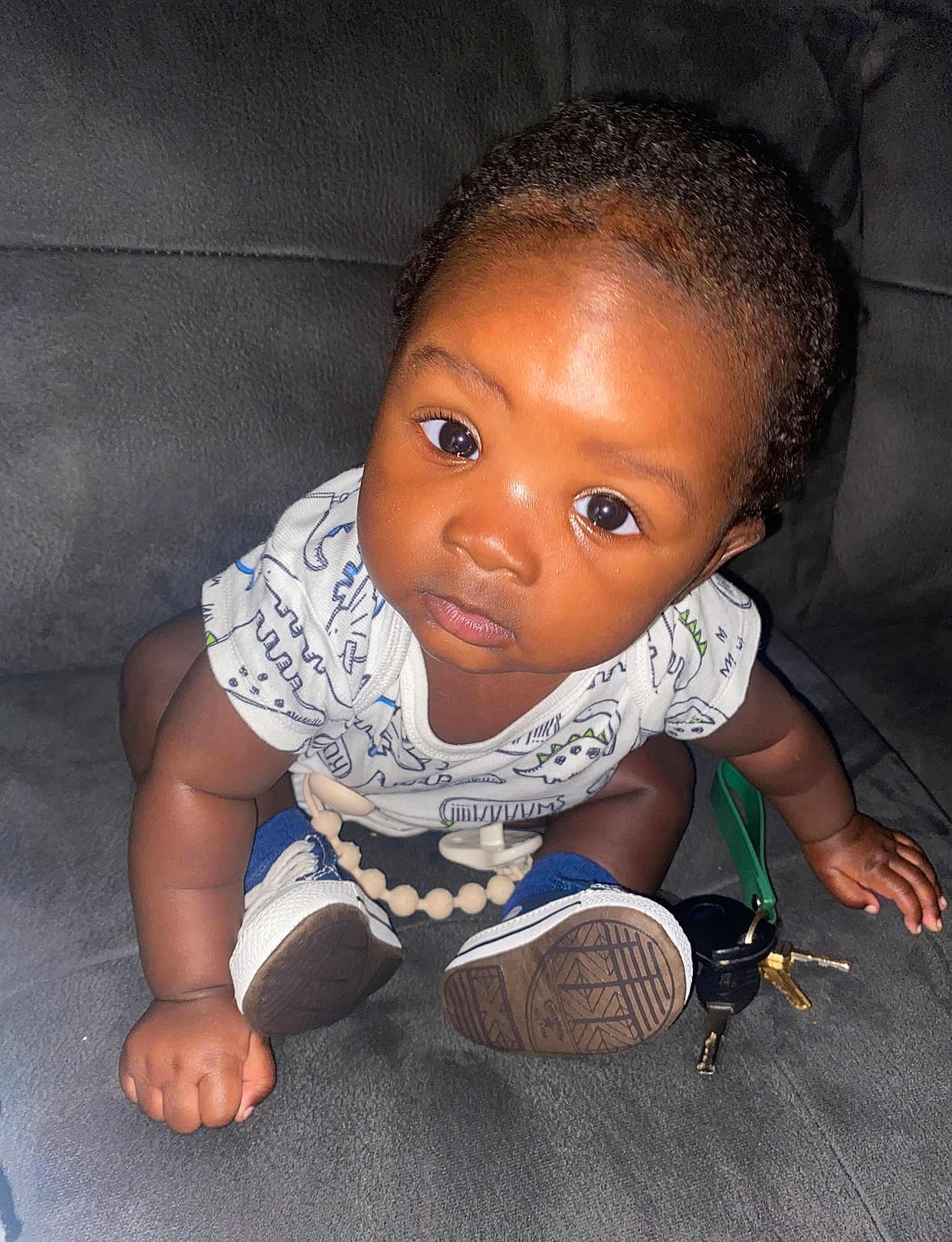 Jobari is registered to the contest to win money with this photo: baby, child, infant, couch, keys, sneakers, onesie, curious, indoor, flash, hand, face, eyes, skin, seated, toy, expression, furniture, person, closeup