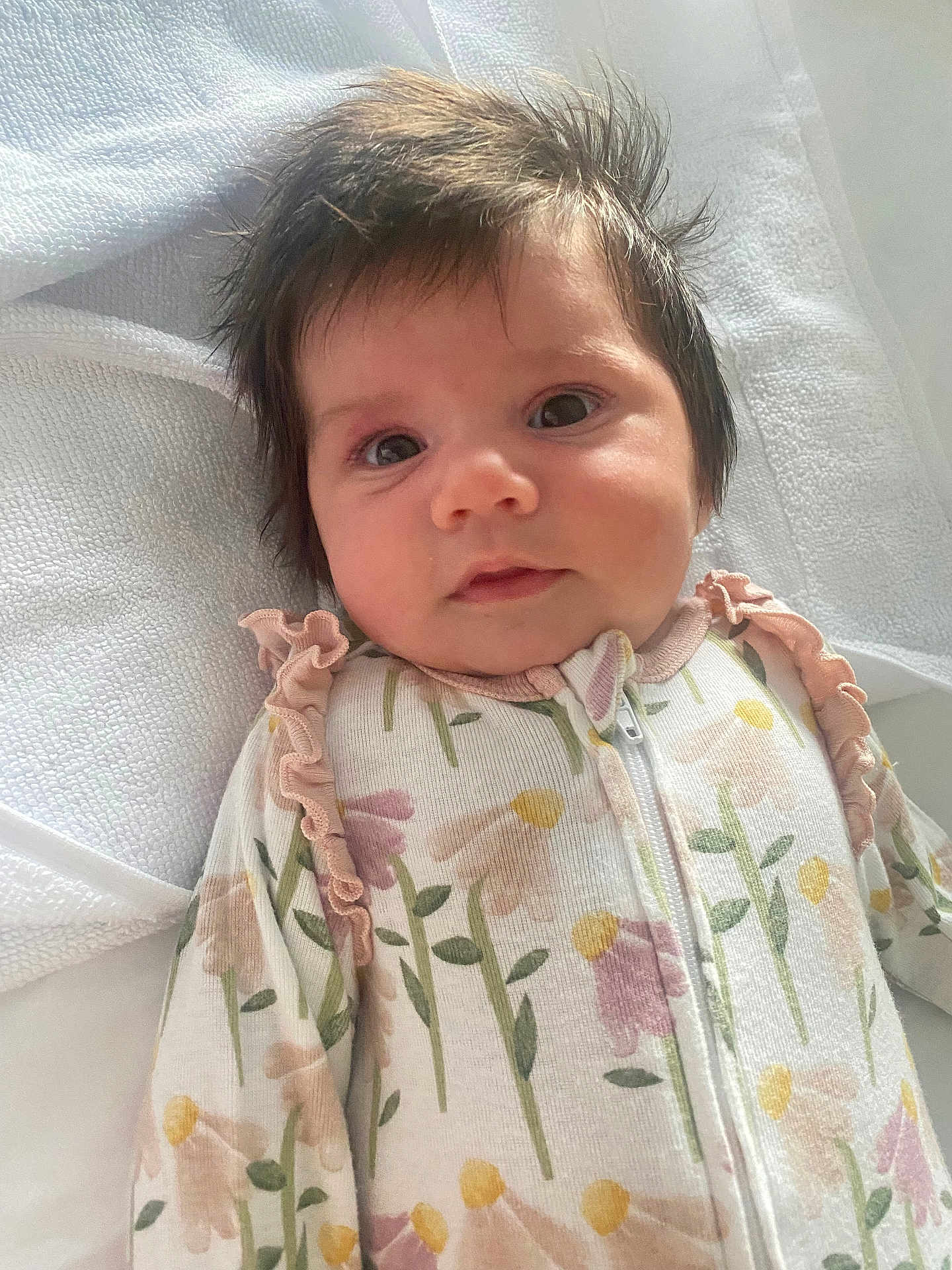 Delaney joined the competition — help win amazing prizes! baby, infant, face, hair, eyes, onesie, floral_pattern, blanket, soft_texture, closeup, cute, child, newborn, portrait, sleepwear, pink, yellow, green, white, indoors