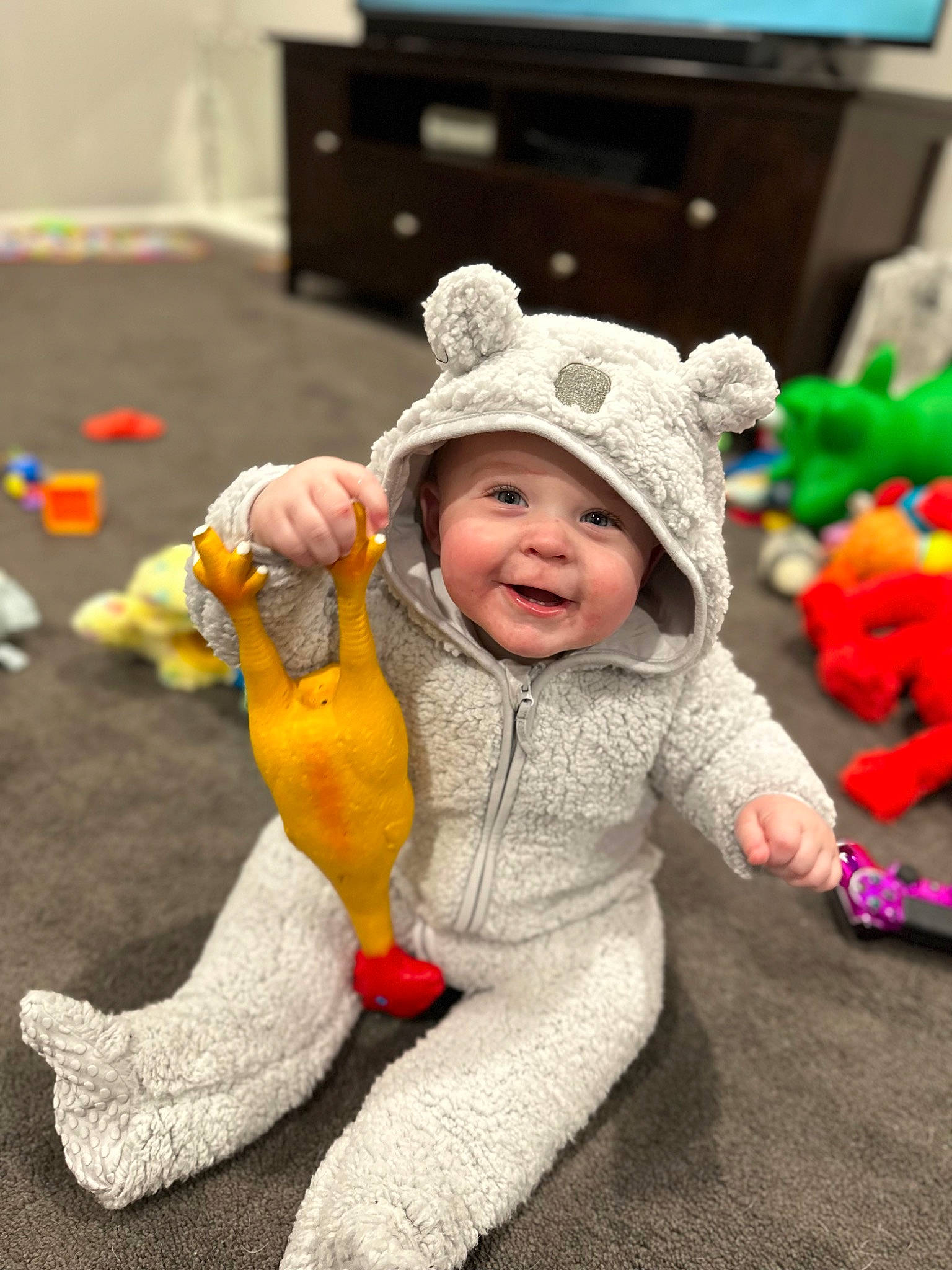 Jordan is registered to the contest to win money with this photo: baby, baby_toddler_clothing, cap, child, computer_keyboard, computer_monitor, costume, event, flooring, fun, fur, grass, happy, hat, headwear, person, play, room, smile, television