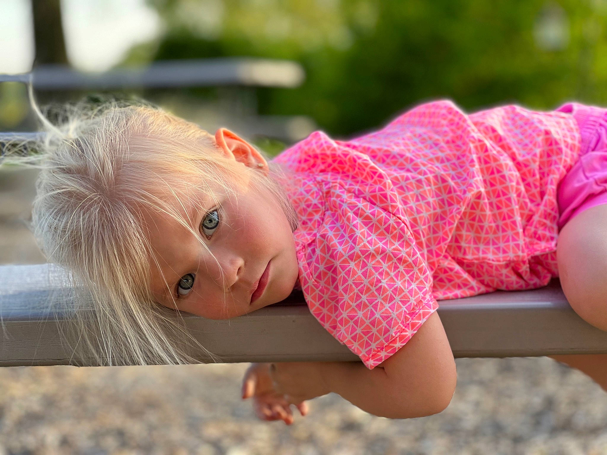 Kamdyn is registered to the contest to win money with this photo: baby_toddler_clothing, child, child_model, fun, grass, happy, leisure, lip, magenta, pattern, people_in_nature, person, photo_shoot, pink, plant, portrait_photography, recreation, sitting, toddler, wood