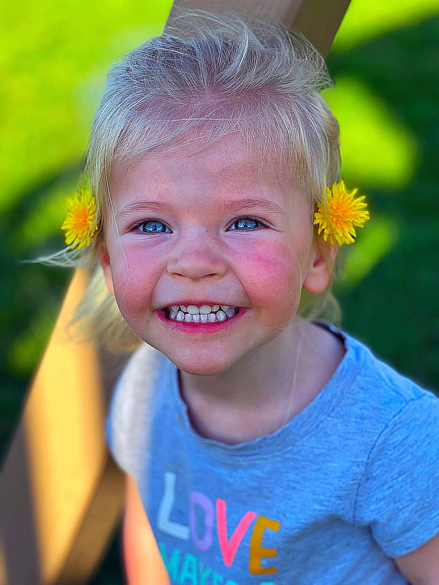 Kamdyn is registered to the contest to win money with this photo: blond, child, close_up, electric_blue, eye, eyelash, flower, fun, gesture, grass, happy, head, headpiece, iris, joy, leisure, neck, people_in_nature, person, skin