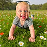 baby, child, grass, flowers, outdoor, smiling, crawling, greenery, sunlight, nature, sunglasses, happy, portrait, field, summer, casual_clothing, toddler, blue_eyes, daytime, playful
