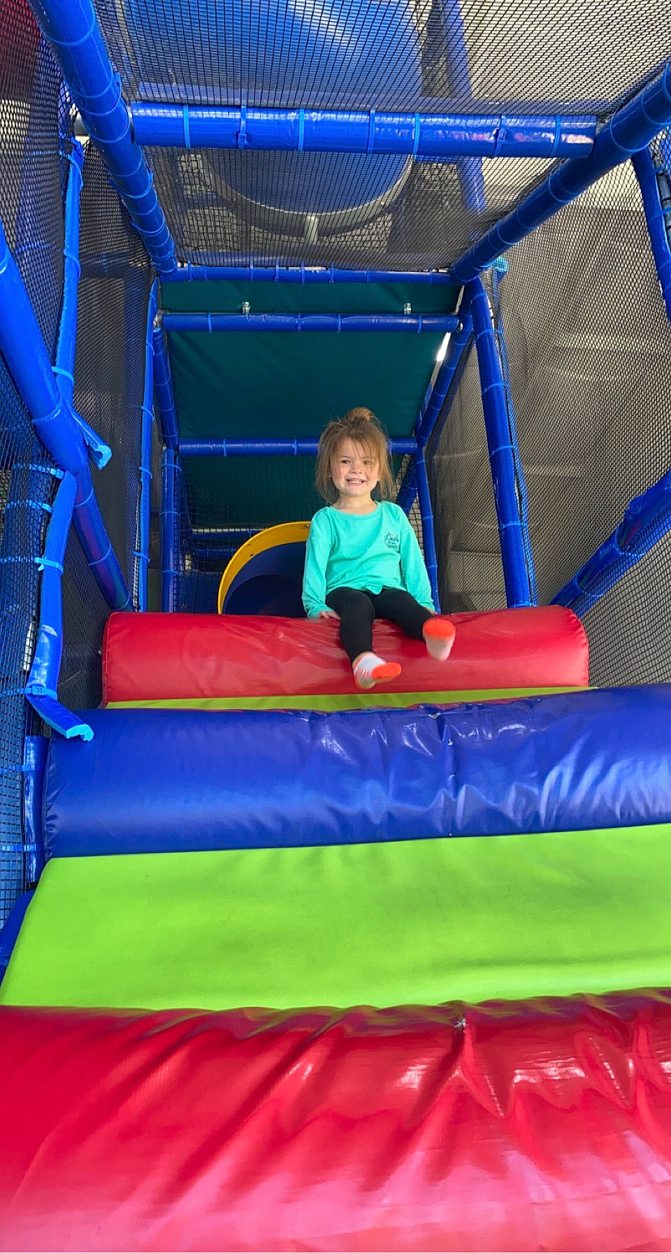 Paisley is registered to the contest to win money with this photo: blue, bounce_house, child, chute, electric_blue, event, fun, games, grass, inflatable, joy, leisure, outdoor_play_equipment, person, play, playground, recreation, red, shade, smile