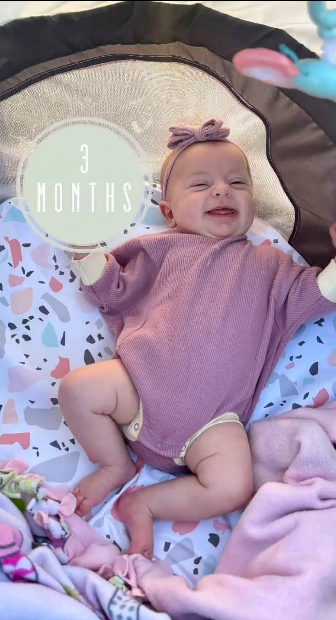 Iris joined the competition — help win amazing prizes! baby, baby_toddler_clothing, cheek, child, comfort, fun, happy, hat, human_leg, lap, pattern, person, pink, product, sitting, skin, sleeve, smile, sock, thigh