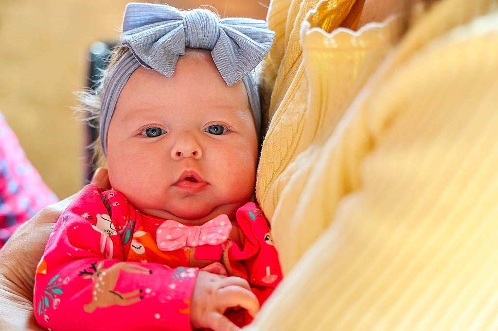 Elsie is registered to the contest to win money with this photo: baby, baby_toddler_clothing, cheek, child, comfort, dress, event, eye, fashion_accessory, fun, grass, happy, headwear, iris, lip, nose, person, sitting, skin, sweetness