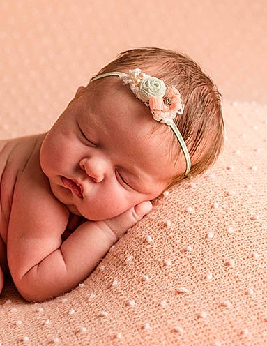 Elsie is registered to the contest to win money with this photo: baby, baby_toddler_clothing, cheek, comfort, eyebrow, eyelash, grass, hair_accessory, happy, headband, headgear, headpiece, linens, lip, nose, person, pink, skin, textile, toddler